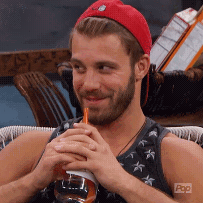 A Man With A Beard Is Drinking Through A Straw From A Bottle . GIF