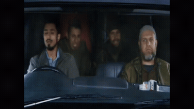 A Man With A Beard Is Driving A Car With Two Other Men Behind Him GIF