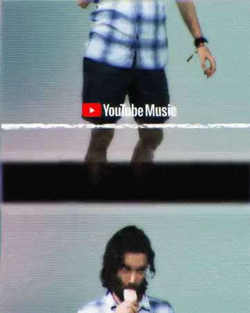 A Man With A Beard Is Eating An Ice Cream Cone In Front Of A Youtube Music Logo GIF
