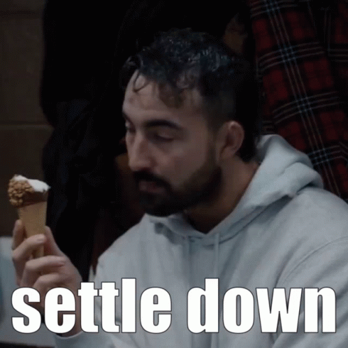 A Man With A Beard Is Eating An Ice Cream Cone With The Words " Settle Down " Below Him GIF