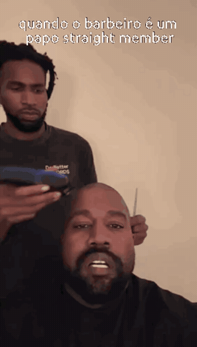 A Man With A Beard Is Getting His Hair Cut By Another Man With Dreadlocks GIF