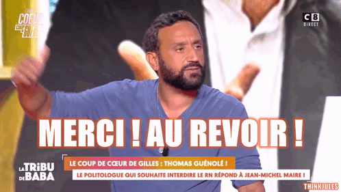 A Man With A Beard Is Giving A Thumbs Up In Front Of A Sign That Says " Merci Au Revoir " GIF