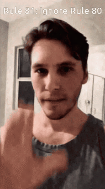 A Man With A Beard Is Giving A Thumbs Up In Front Of A Sign That Says Rule 81 : Ignore Rule 80 GIF