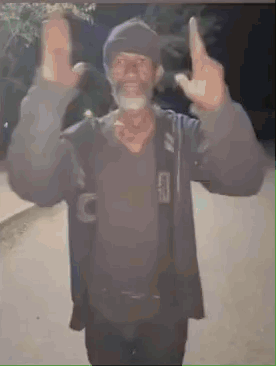 A Man With A Beard Is Giving The Middle Finger While Wearing A Hat . GIF