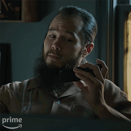 A Man With A Beard Is Holding A Black Object And Asking What Do You Think GIF