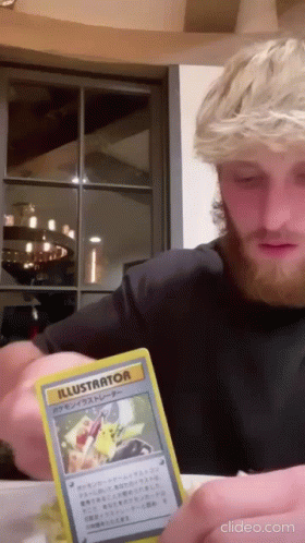 A Man With A Beard Is Holding A Card That Says Illustrator GIF
