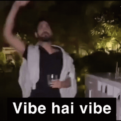 A Man With A Beard Is Holding A Glass Of Beer And Dancing In A Video . GIF