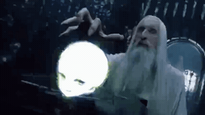 A Man With A Beard Is Holding A Glowing Ball In His Hand . GIF