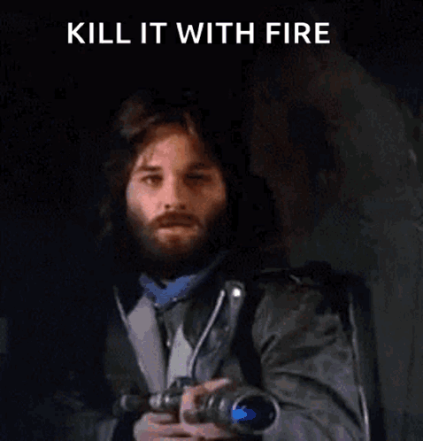 A Man With A Beard Is Holding A Gun With Flames Coming Out Of It And The Words `` Kill It With Fire '' . GIF