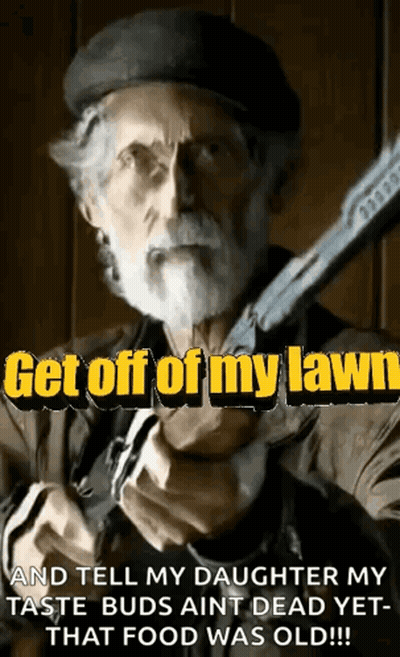 A Man With A Beard Is Holding A Gun With The Words Get Off Of My Lawn GIF