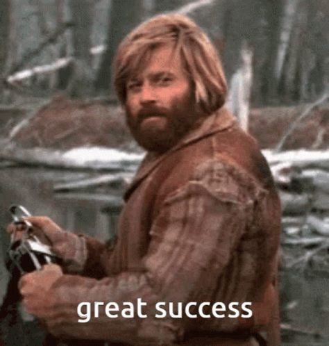 A Man With A Beard Is Holding A Gun With The Words Great Success Written Below Him GIF