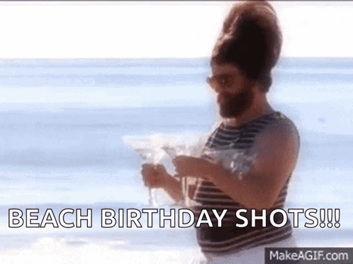 A Man With A Beard Is Holding A Martini On The Beach And Says Beach Birthday Shots . GIF