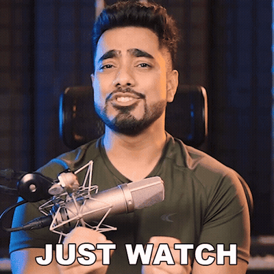 A Man With A Beard Is Holding A Microphone And Says " Just Watch " GIF