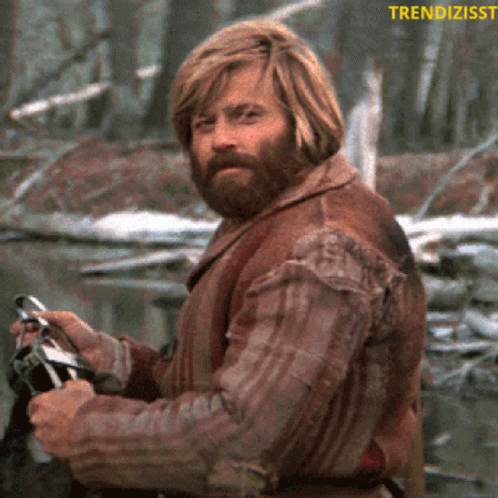 Man With Beard Holding Binoculars In Front Of Trendzisst Logo GIF
