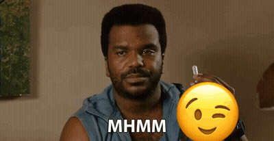 A Man With A Beard Is Holding A Pen And A Smiley Face With The Word Mhmm Written On It GIF