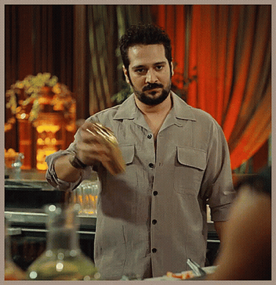 A Man With A Beard Is Holding A Piece Of Food GIF