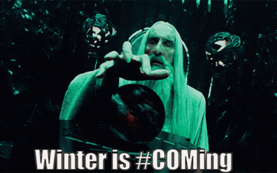 A Man With A Beard Is Holding A Red Ball With The Words Winter Is # Coming Below Him GIF