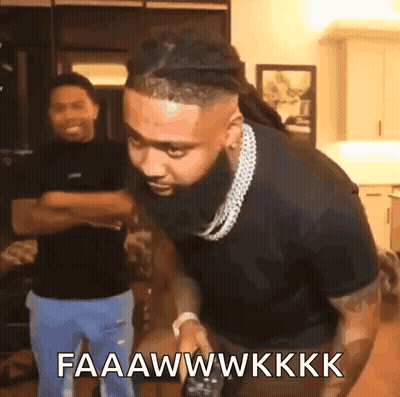 A Man With A Beard Is Holding A Remote Control And Says Faaawwkkk GIF