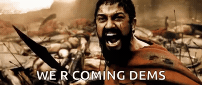 A Man With A Beard Is Holding A Sword And Screaming In A Battle Scene From The Movie 300 . GIF