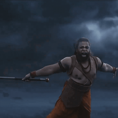 A Man With A Beard Is Holding A Sword In His Hands GIF