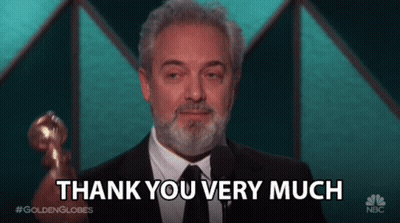 A Man With A Beard Is Holding A Trophy And Saying Thank You Very Much GIF