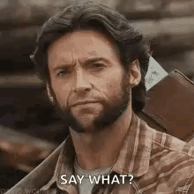 A Man With A Beard Is Holding A Wallet And A Ticket And Saying `` Say What '' . GIF