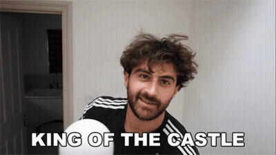 A Man With A Beard Is Holding A White Ball With The Words King Of The Castle Above Him GIF