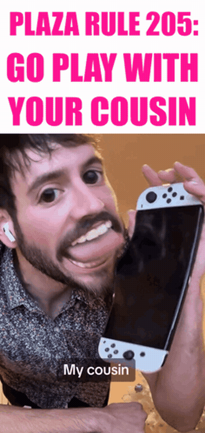A Man With A Beard Is Holding A White Nintendo Switch In His Hand GIF