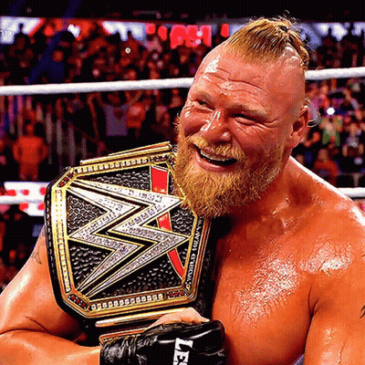 A Man With A Beard Is Holding A Wrestling Belt That Says Wwe GIF