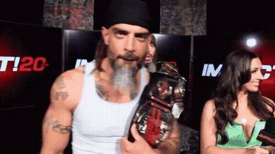 A Man With A Beard Is Holding A Wrestling Championship Belt GIF