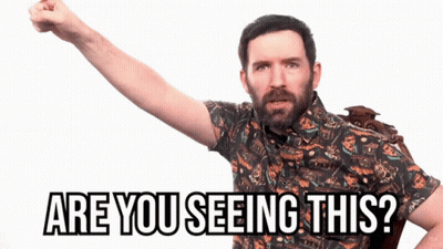 A Man With A Beard Is Holding His Fist Up And Says Are You Seeing This GIF