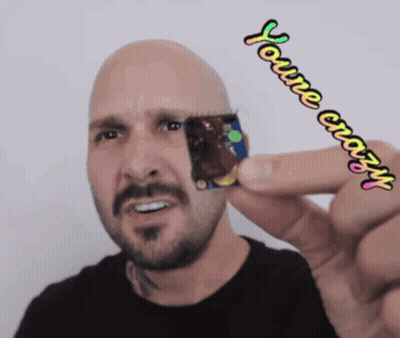 A Man With A Beard Is Holding Something In His Hand And Says " You 'Re Crazy " On The Bottom GIF