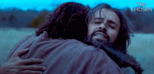 A Man With A Beard Is Hugging Another Man With The Words " The Chosen " Above Them GIF