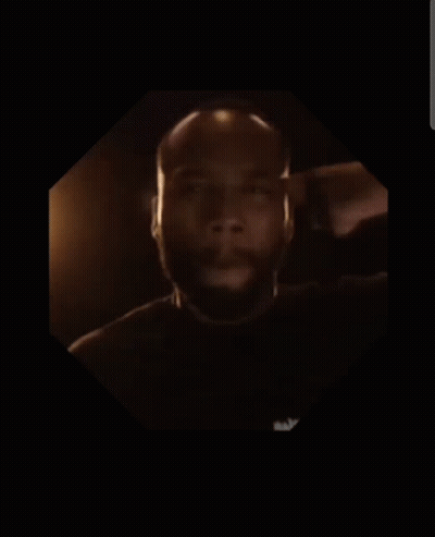 A Man With A Beard Is In A Dark Room GIF