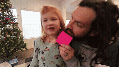 A Man With A Beard Is Kissing A Little Girl Who Is Wearing A Minnie Mouse Outfit GIF