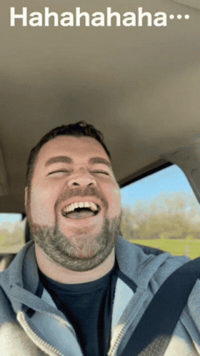 A Man With A Beard Is Laughing In A Car With A Caption That Says " Hahahahaha " GIF
