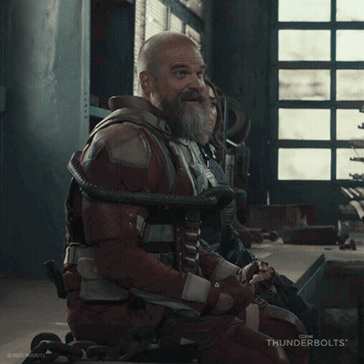 A Man With A Beard Is Laughing While Sitting In A Wheelchair GIF