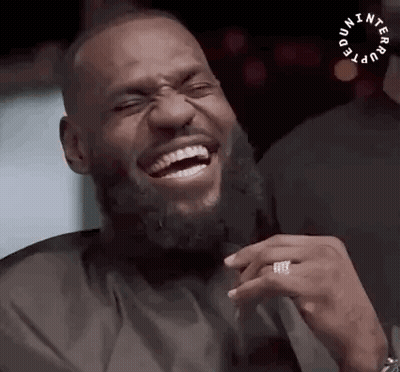A Man With A Beard Is Laughing With His Eyes Closed And A Ring On His Finger . GIF