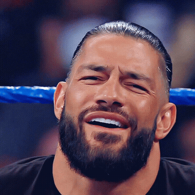 A Man With A Beard Is Laughing With His Eyes Closed GIF