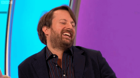 A Man With A Beard Is Laughing With His Eyes Closed GIF