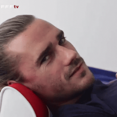 A Man With A Beard Is Laying Down With His Head On A Pillow GIF