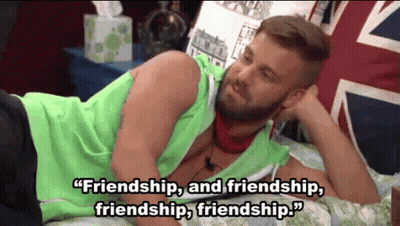 A Man With A Beard Is Laying On A Bed With A Quote About Friendship . GIF
