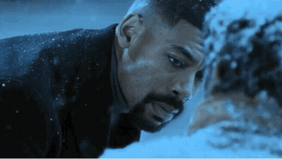 A Man With A Beard Is Looking At Another Man 'S Face In The Snow . GIF