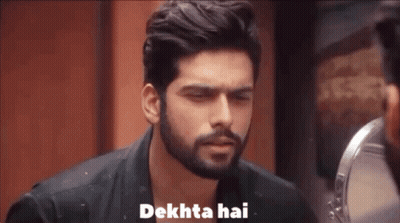 A Man With A Beard Is Looking At Himself In A Mirror And Saying Dekhta Hai . GIF