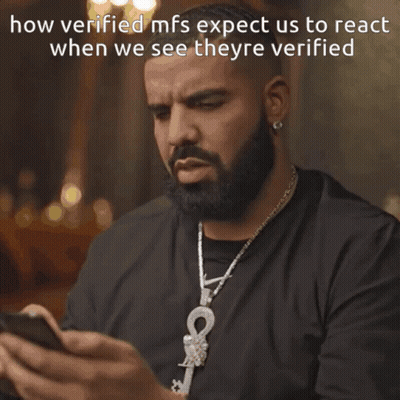 A Man With A Beard Is Looking At His Phone With The Words Wow Written Below Him GIF