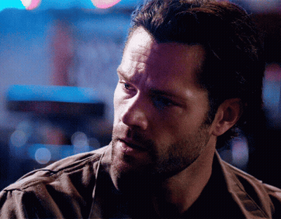 A Man With A Beard Is Looking At Something GIF