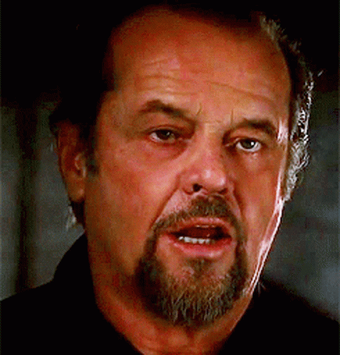 A Man With A Beard Is Looking At The Camera GIF