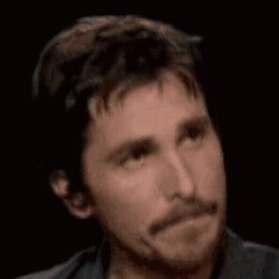 A Man With A Beard Is Looking At The Camera With A Serious Look On His Face GIF