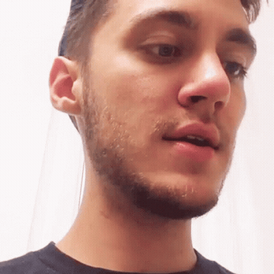 A Man With A Beard Is Looking At The Camera With His Mouth Open GIF