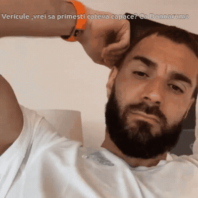 A Man With A Beard Is Looking At The Camera With The Caption Vericule Vrei Sa Primesti Cateva Capace GIF